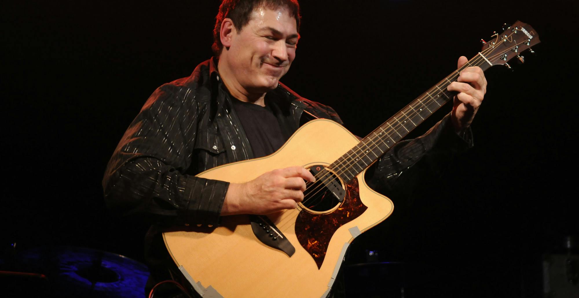 Don Alder playing the guitar.