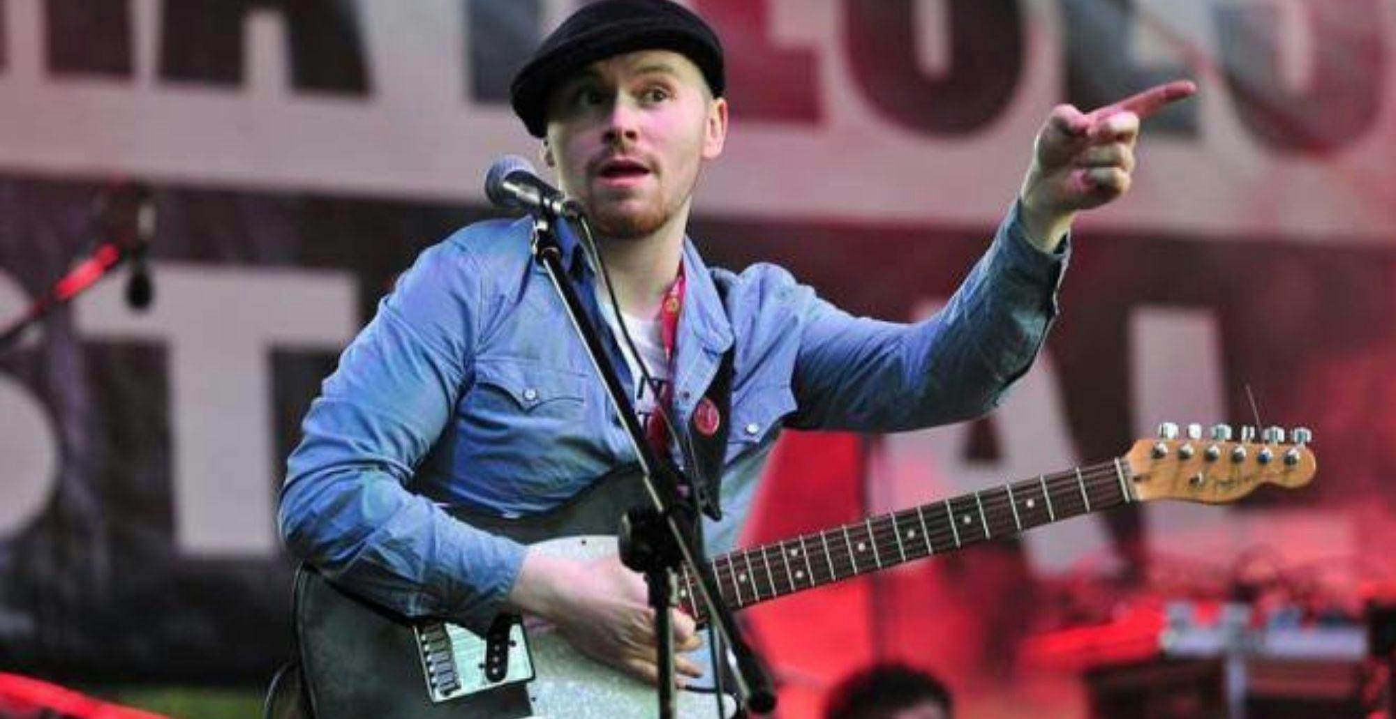 Mitch Laddie playing guitar live on stage